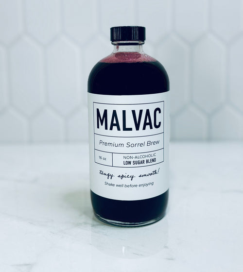 One bottle of MALVAC Premium Sorrel Brew Low Sugar Blend on a white tiled background.