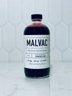 One bottle of MALVAC Premium Sorrel Brew Signature Blend on a white tiled background.